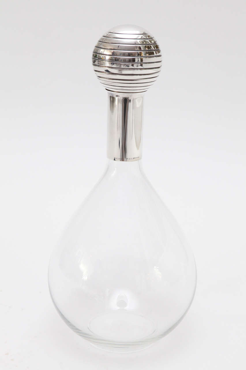 A large-scale crystal and silver plate decanter from Riedel's Mesa collection topped with a 3.25