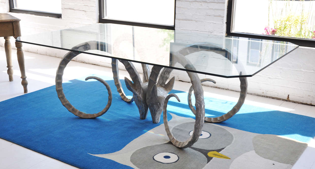 Glass top table with Ibex head base