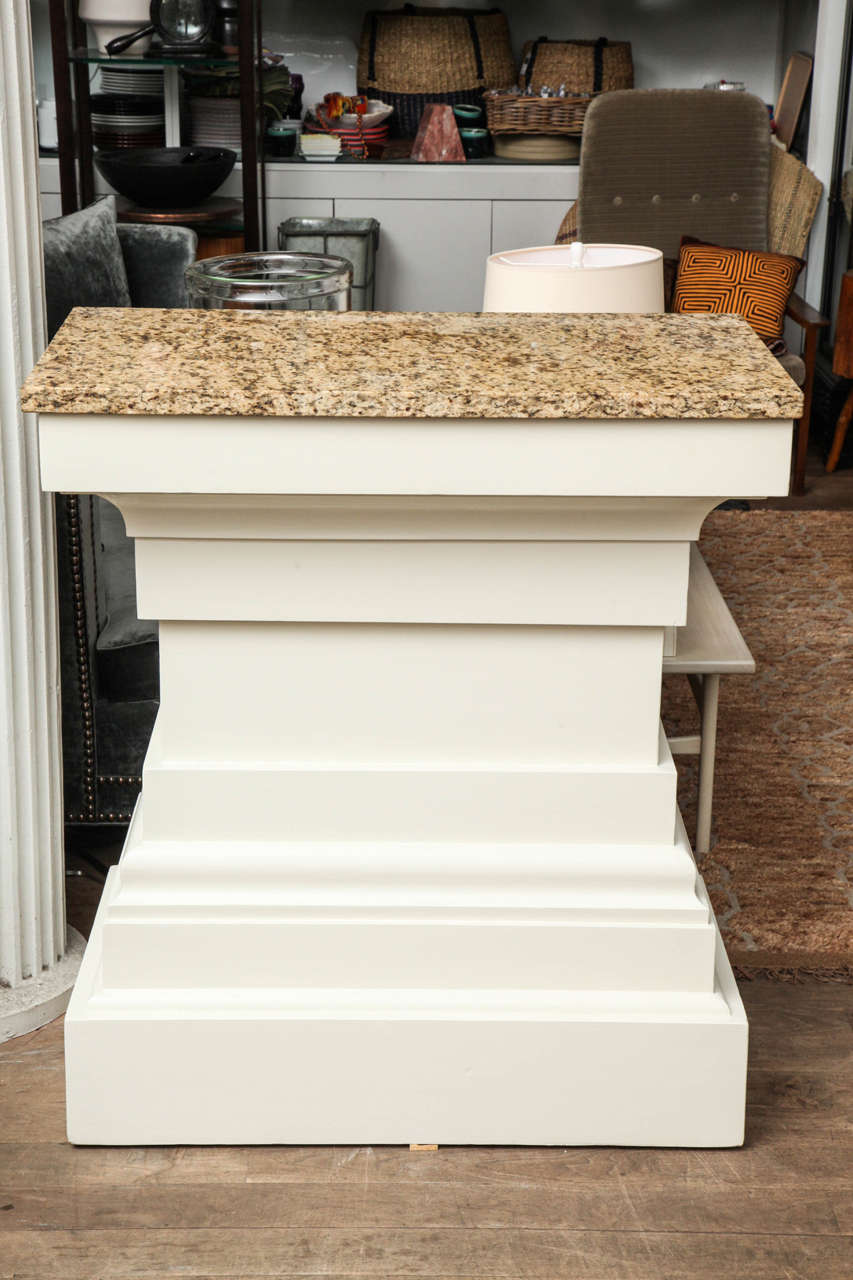 Painted timidity white, this vintage lectern makes a commanding entry table or art/plant pedestal, with a granite top circa 1930.