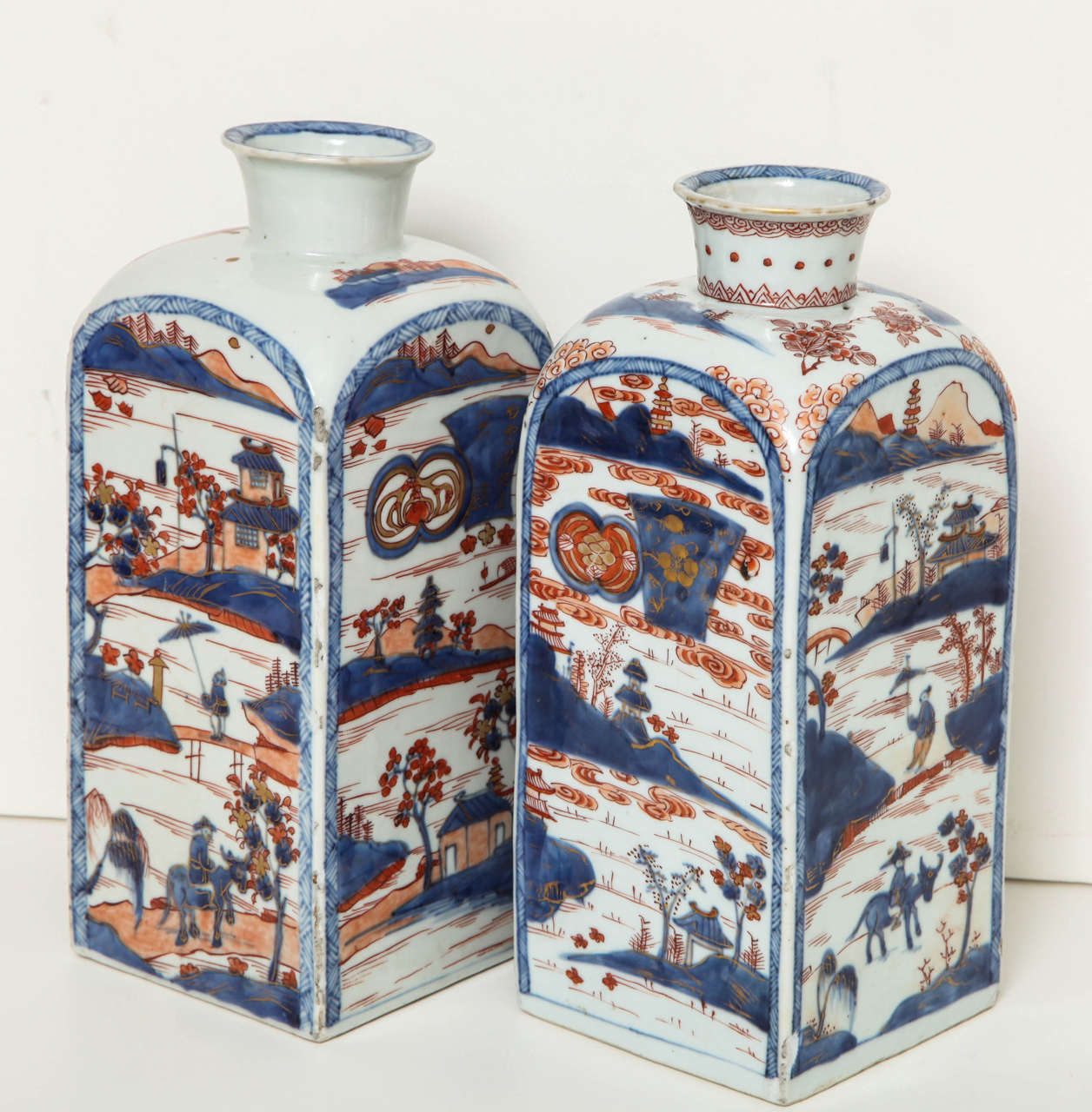 An unusual pair of 18th century Chinese square vases with shaped necks
polychrome decorated with figures in a watery landscape scene