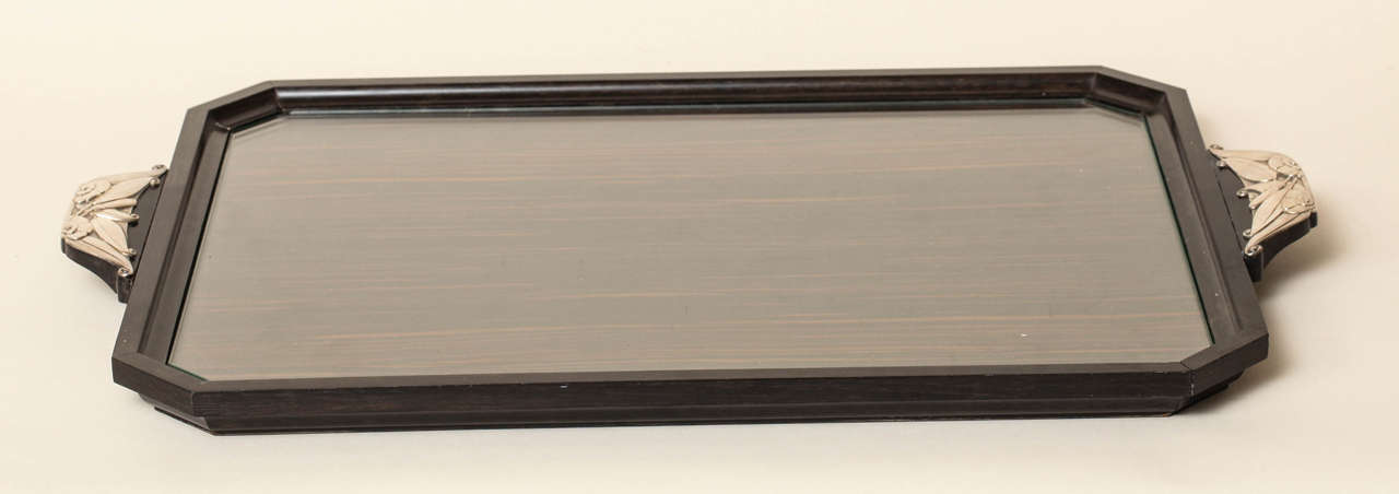 Elegant rectangular tray with angled corners in Macassar ebony with solid ebony border.
Interior with fitted glass.
Handles with floral motif in 950 silver.
Hallmarked for 950 silver with Minerve and with Fernand Grange poincon.