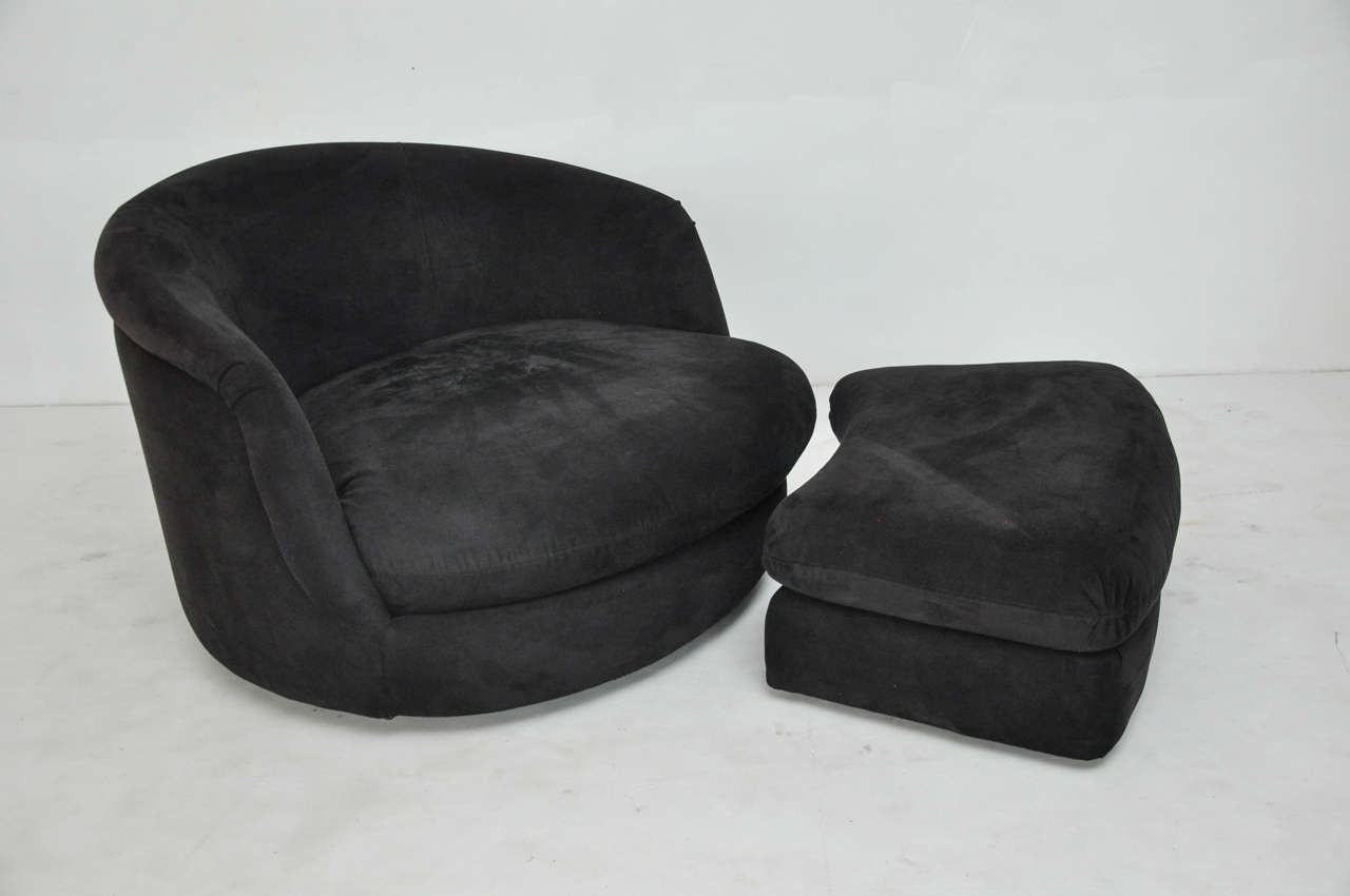 Large Milo Baughman swivel chairs with rolling ottoman.