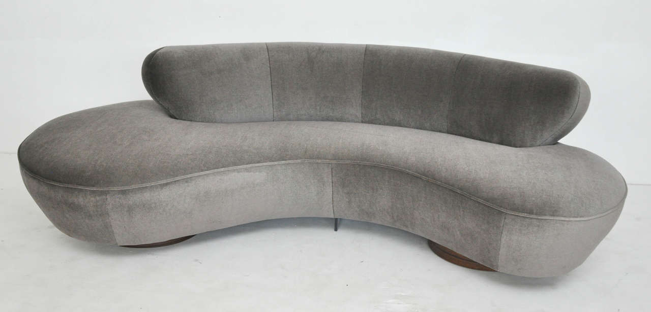 Serpentine sofa by Vladimir Kagan. Newly upholstered in grey mohair over walnut bases.