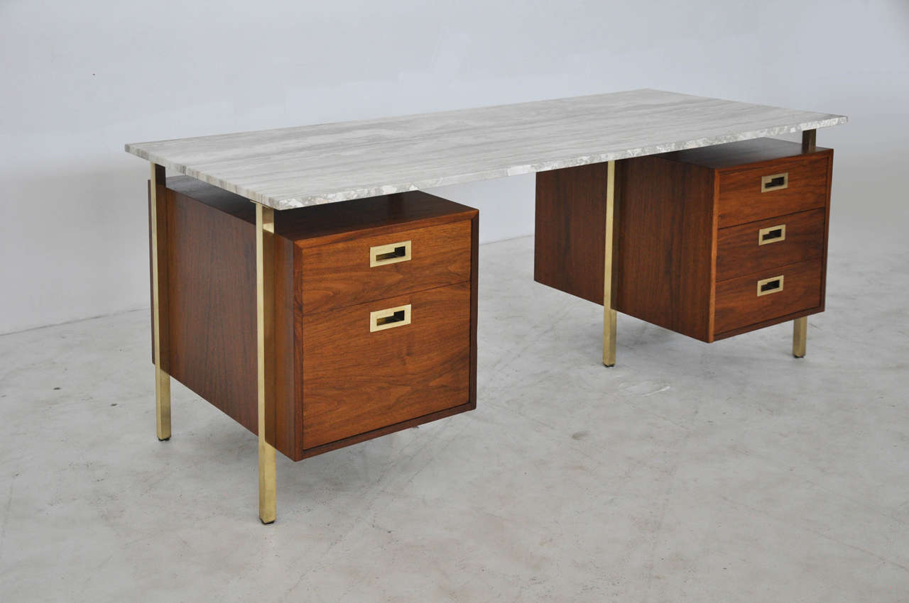 Walnut double pedestal desk with brass legs and pulls. Beautiful travertine top. Fully restored.