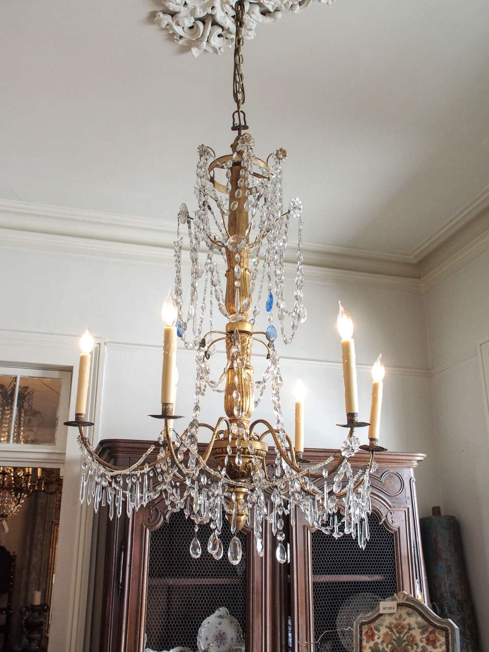 18th century six lights Genoa chandelier. Four tiers with a top crown, three blue crystal on top. Carved giltwood body and six gilded iron arms. US wired.