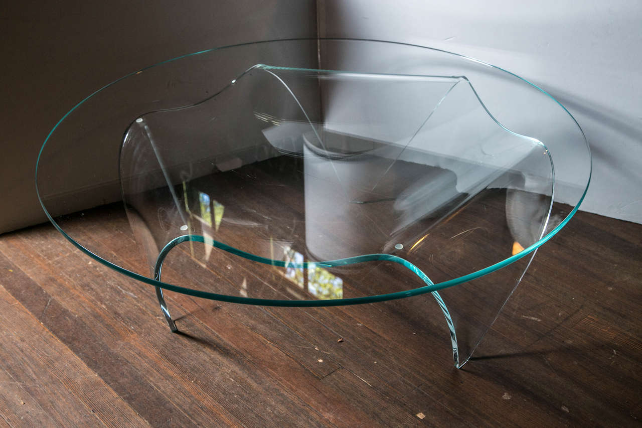 Tripod glass base and round top glass coffee table.