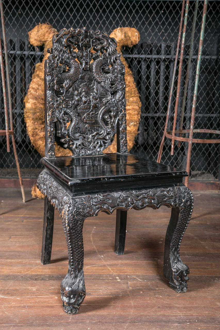 Exotic and dramatic pair of intricately carved side chairs. Three pairs are available.