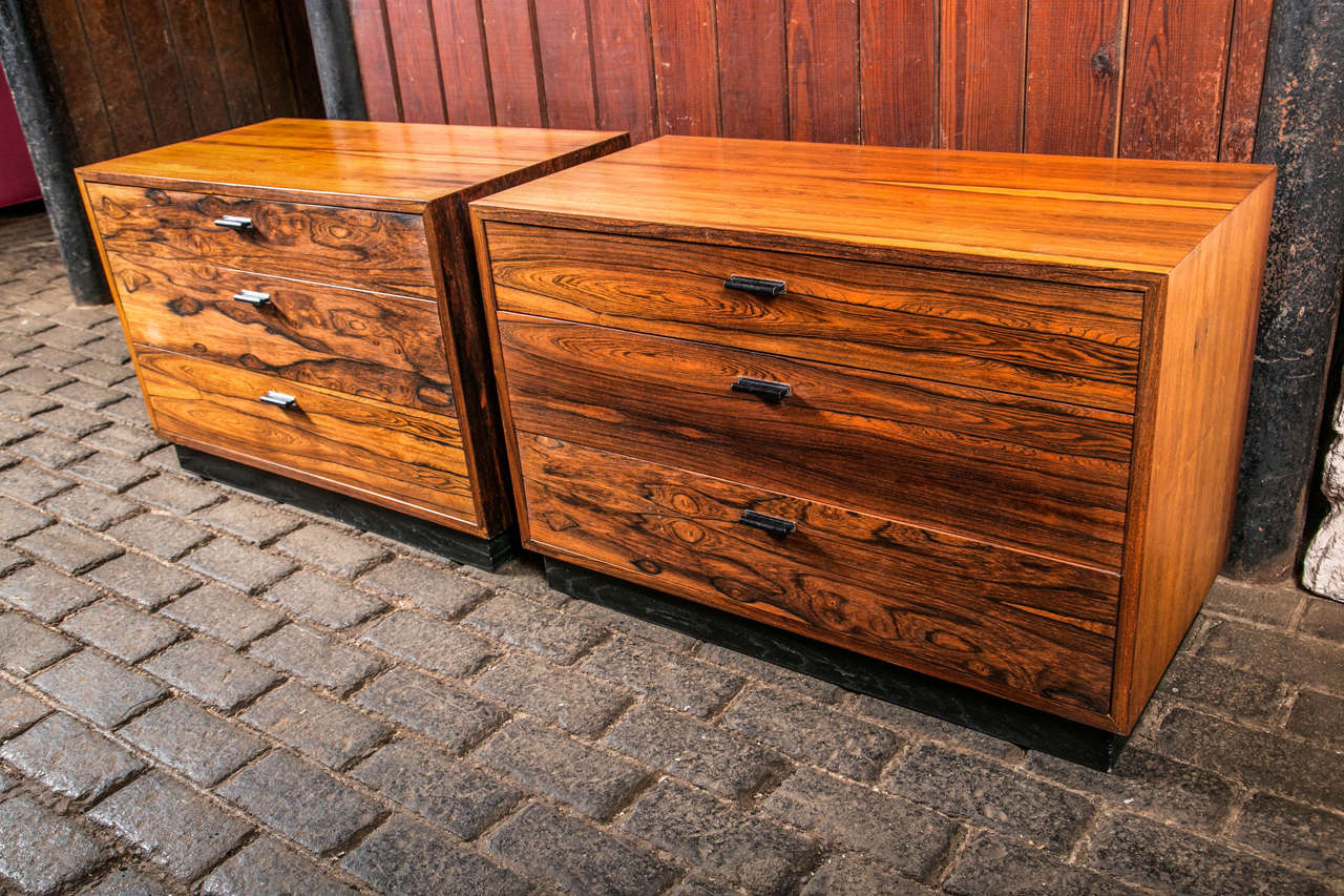 Pair of streamlined three-drawer rosewood bedside chests by Harvey Probber.