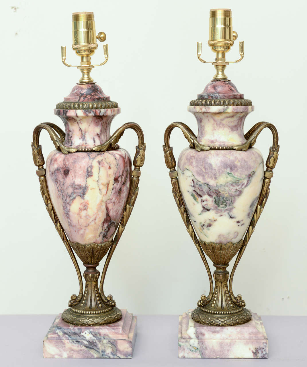 Fine pair of Louis XV rouge marble lamped urns, with bronze mounts; compana form with double foliate scrolling handles, both with waisted socle decorated with laureling, on square plinth.

Stock ID: D6613
