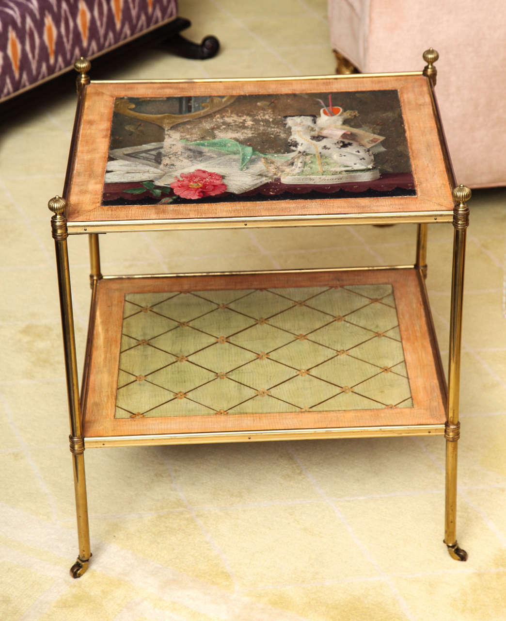 Painted table with brass mounts and casters. The top is inset with a still life painting of a china dog, glove, flower and book.
American, c. 1950