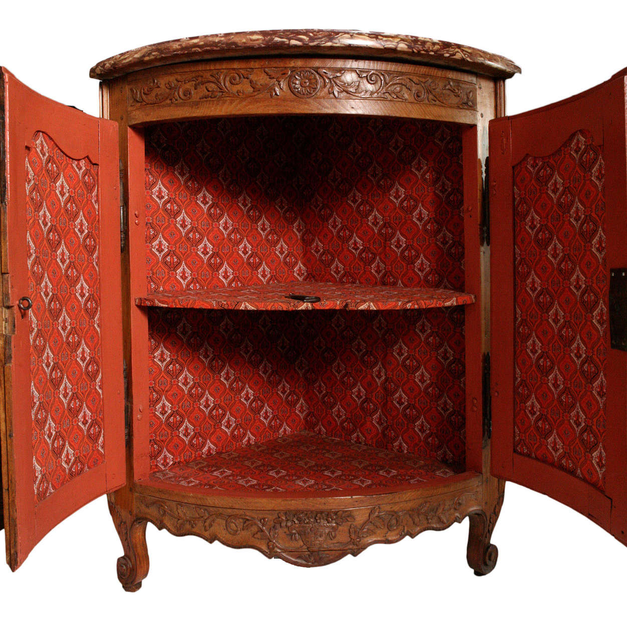 Bowfront corner cabinet with original rouge marble top.  Carved frieze, apron and feet.  Painted interior with fabric.  Lock and key.