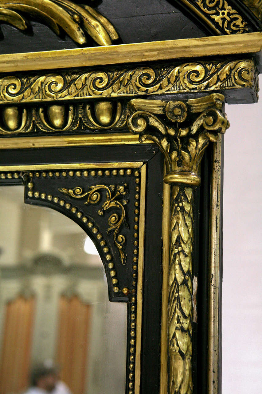 A very nice french Renaissance mirror with broken arched pediment. Black finish with gold highlights.