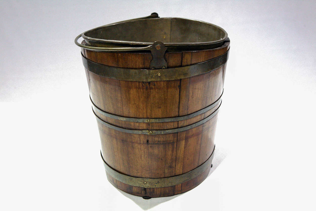 A 19th Century Peat Moss Boat Shaped Bucket with brass straps, handle and liner. 