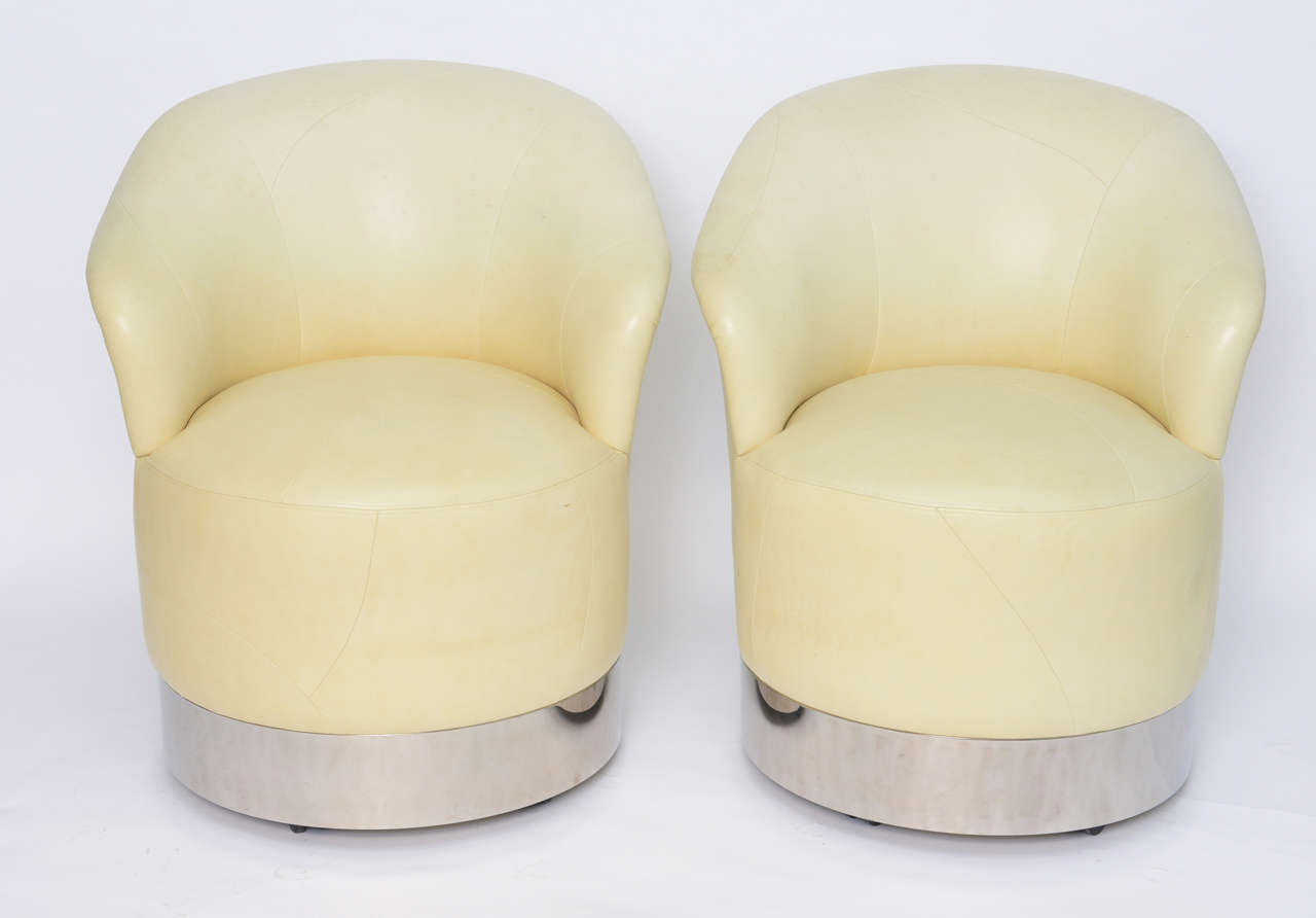 
Exceptional chairs by noted California designer Sally Sirkin Lewis for her firm, J. Robert Scott, this pair of ultra soft baby lambskin upholstered chairs rock and swivel on unseen casters beneath the polished stainless steel bases. Soft &