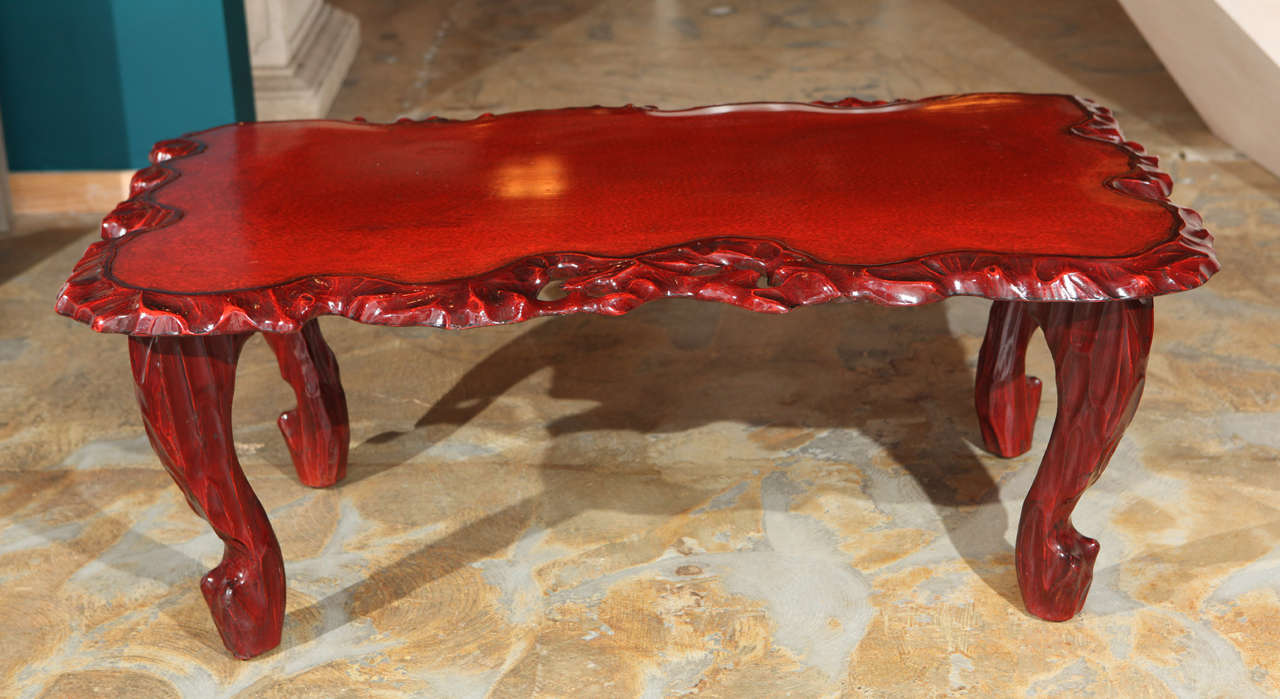 1930s red lacquered Chinese coffee table, the legs and top were carved in the manner of root. 
Visit the Paul Marra storefront to see more furnishings and lighting including 21st Century.