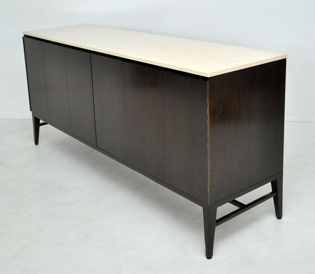 Dark espresso finish sideboard with travertine top.  Designed by Paul McCobb for Calvin Furniture.
