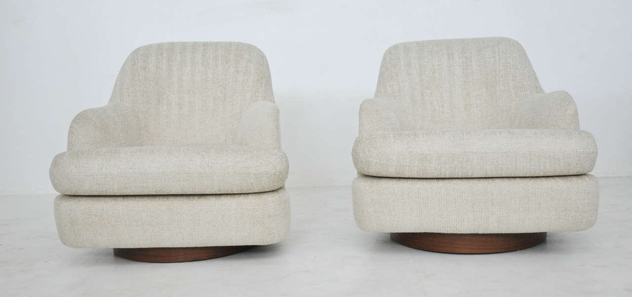 Swivel chairs designed by Milo Baughman for Directional.  Fully restored walnut bases.  Newly upholstered.