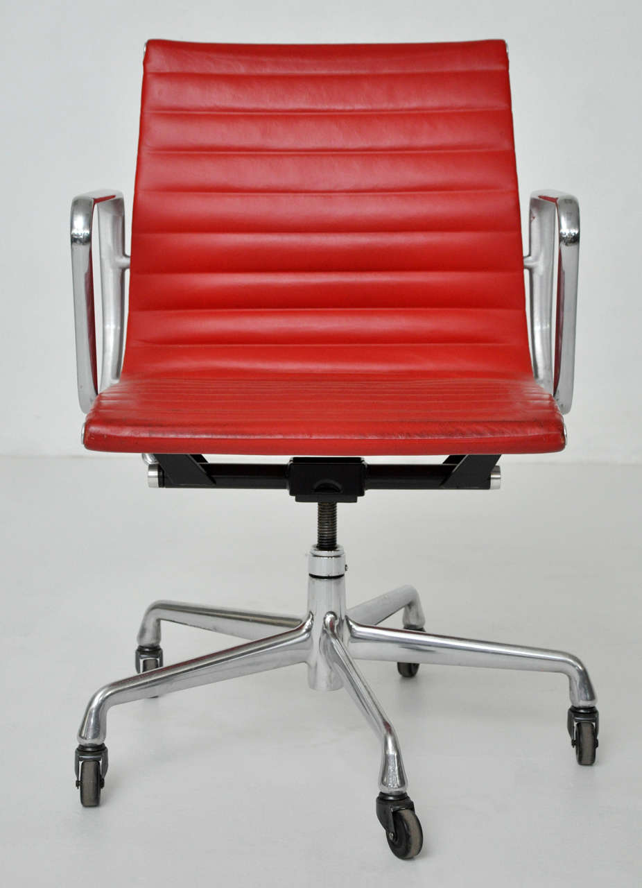 50th anniversary aluminum group Management Chairs.  Original red leather.  Designed by Charles Eames for Herman Miller.  Adjustable height.

**8 chairs available.