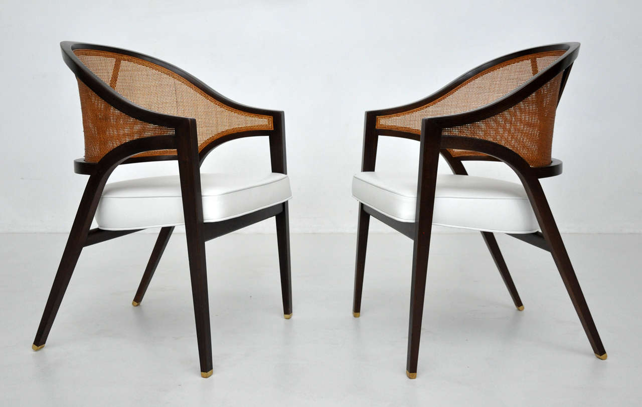 Pair of arm chairs designed by Edward Wormley for Dunbar.  Fully restored in espresso tone with white leather seats.