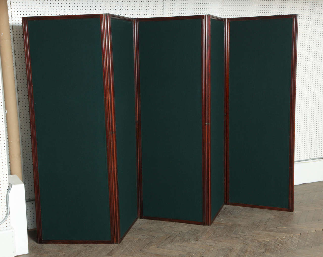 This is an antique screen or divider made of mahogany and inset with fabric. These screens were historically used to block off or hide areas of the room with servers or dining prep during the victorian era. 

MEASUREMENTS BELOW PER PANEL
