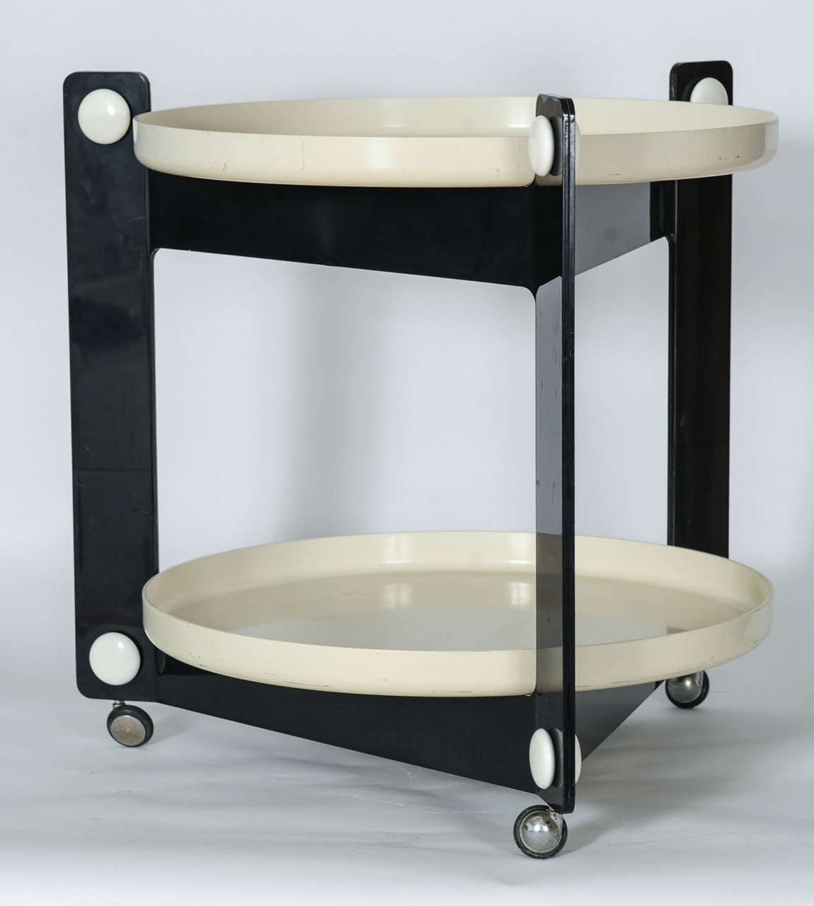 Very stylish trolley in black and off-white by Guzzini. 
The two detachable serving trays have a diameter of 56 centimeters.
The wheels allow for easy use at pool side or cocktail bar.