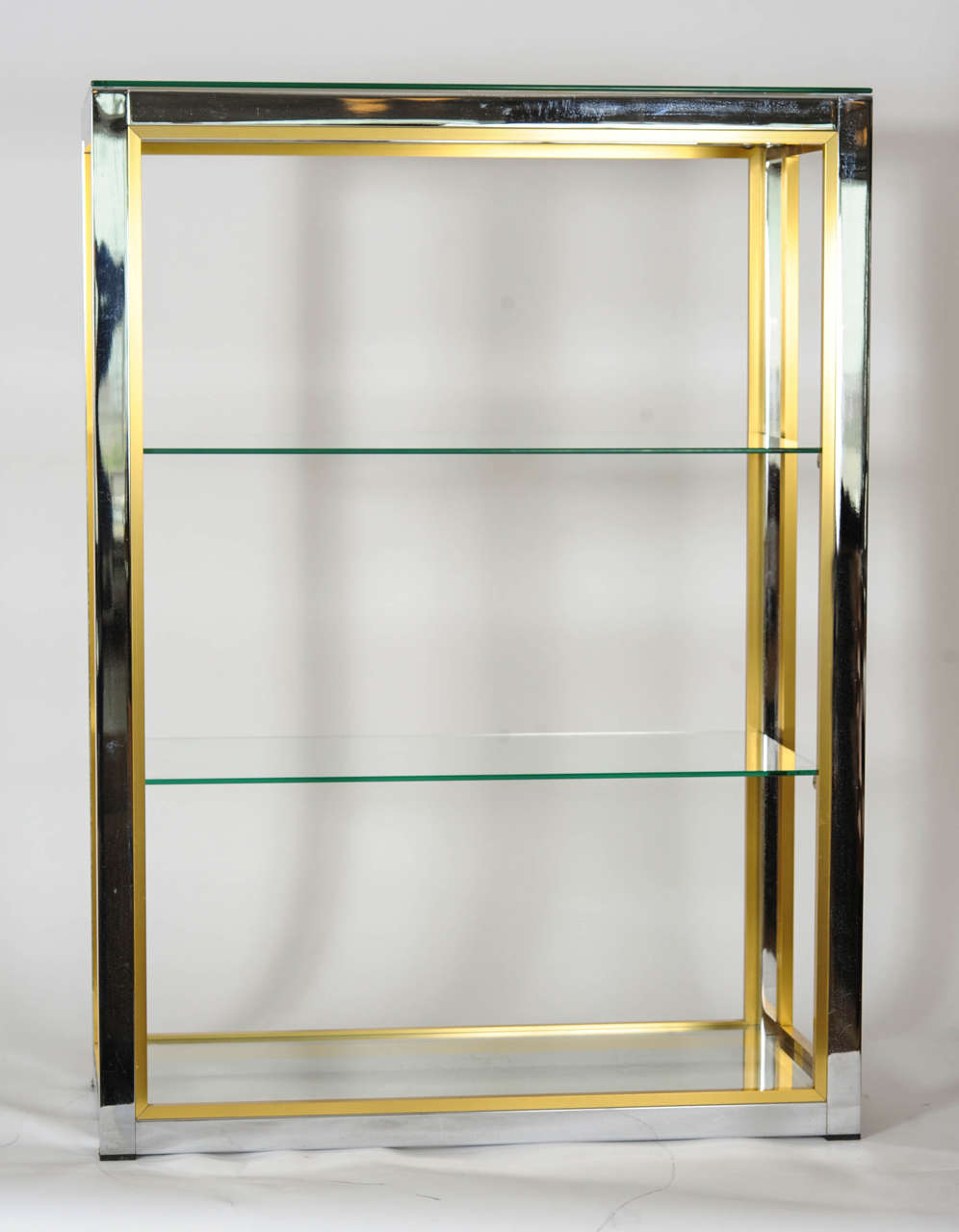 Sleek mix of brass and chrome base with glass shelves.

This set of two Etagères by Renato Zevi may be used as a room divider as well as a set of cupboards due to the high profile finish all around.

Great display for your beloved knick knacks.
