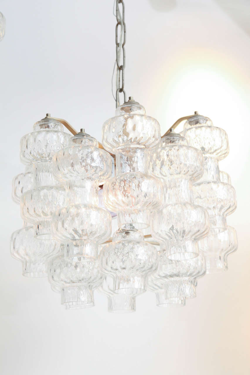 Pair of original Mid-Century Modern Italian vintage Murano clear glass pendants with individual handblown glass elements. Chrome frame and chain. Rare to find a matching pair of these. Each fixture has three-light bulb sockets. Height of chandelier