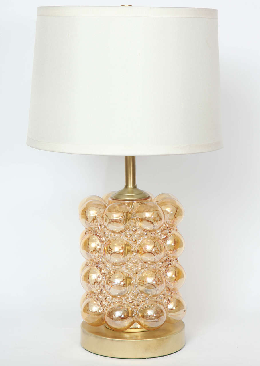 Striking pair of champagne colored bubble glass lamps sitting on satin brass disc bases, designed by Helena Tynell. Rewired for use in the USA with brass hardware. Shades not included.