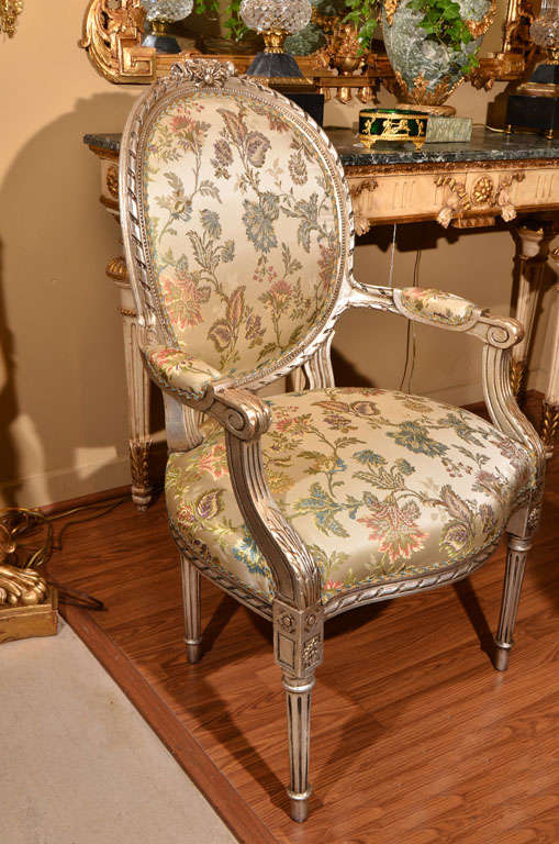 pr of 19th c Louis XVI silver leafed oval backed open armchairs