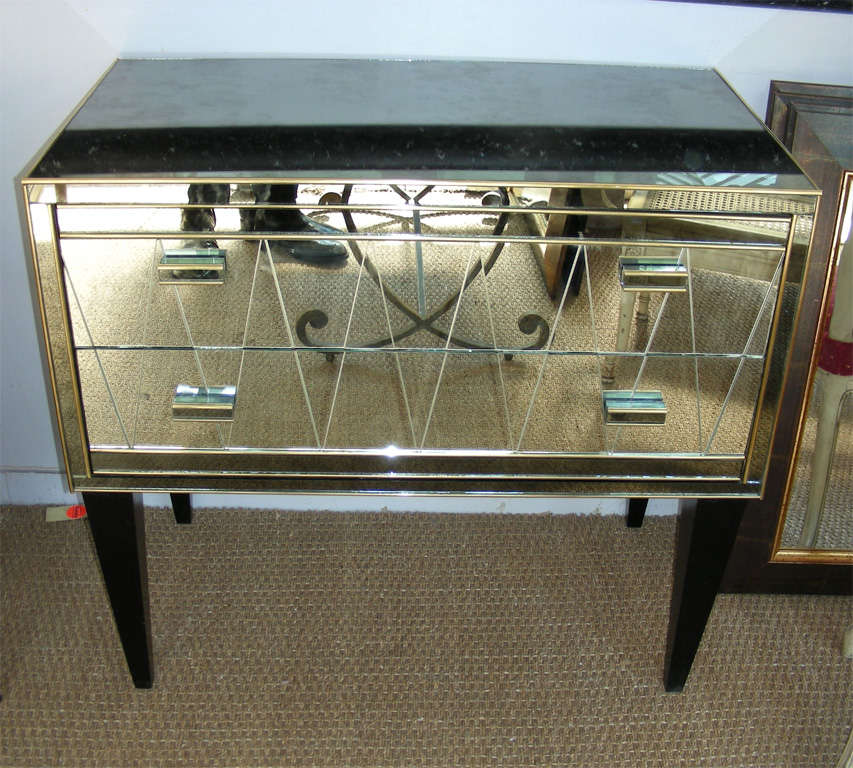 Pair of commodes in mirror.