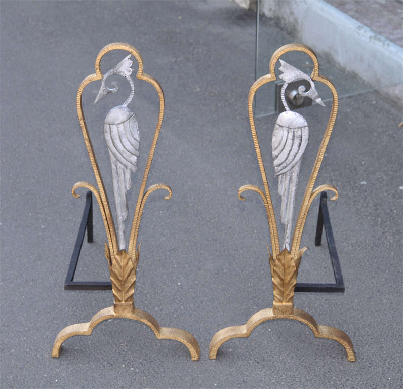 Two 1930s andirons attributed to Edouard Schenck, in patinated wrought iron.