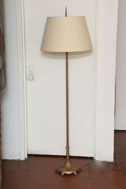 Classical and chic lighting piece. The goldie floor lamp has an unique lightness. The classical design of the lamp can complement any style. It received updated electrical work. It has a linen shade and the iron base has a goldie and bronze finish.