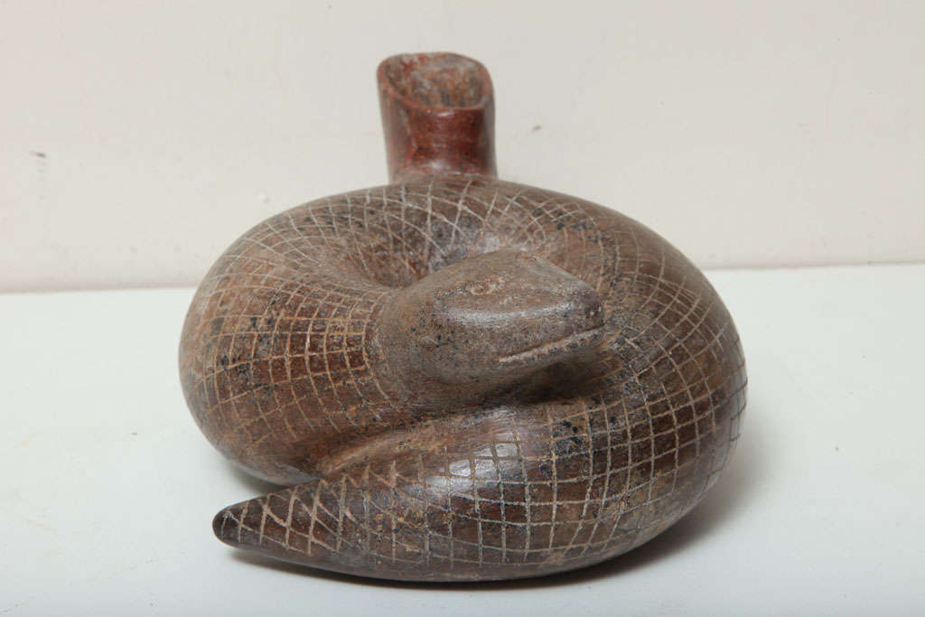 A hollow pottery coiled snake red-brown  with incised  hatched body decoration.

 


Provenance: Ex Dr. R. Boyd Stifler, Vanderwagen NM.