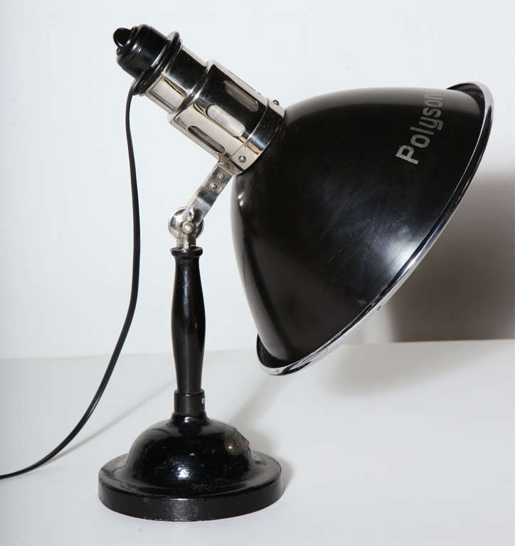 Large early 20th century articulating Black & Silver Polysonn-Lampe Health Spa Table Lamp.  Featuring a black enameled adjustable (15D) exterior shade with printed Polysonn name, reflective nickel interior on a weighted round Black enameled gloss