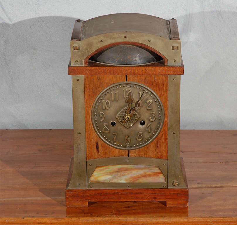 A good German 14 day mantle clock, circa 1910, in the Arts & Crafts style.The clock has a tag on the inside for a English retailer and was purchased in England.  This will make a good accessory for all types of settings. Jefferson West offer a large