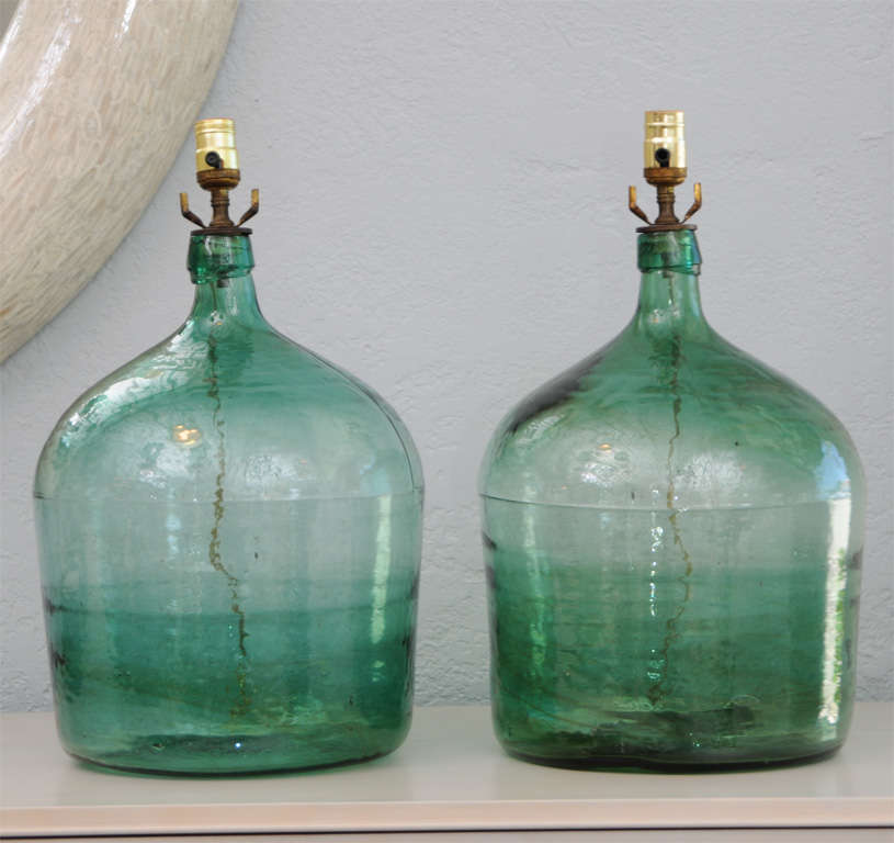 Captivating green color on this gorgeous pair of lamps, made from early 20th century French wine jugs. (Shades not included.)