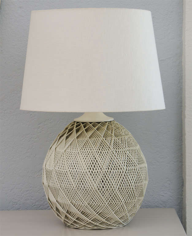 Buckminster Fuller meets beach house in this pair of beguilingly graphic woven rattan lamps in original off-white paint. (Shades not included.)