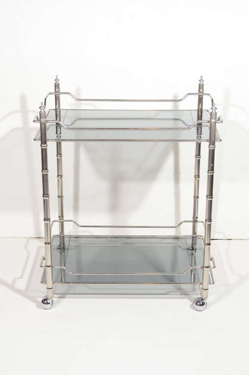 Hollywood Regency bar cart with bamboo motif in chrome. Two-tier design with tinted smoked grey glass tops.