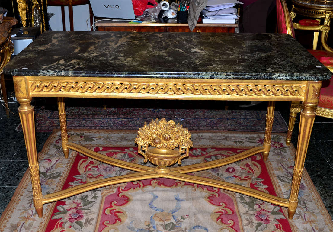 LARGE CONSOLE GILDED AND CARVED WOOD LOUIS XVI PERIOD
ORIGINAL & VERY RARE GREEN MARBLE TOP 
SUPPORTED BY 4 FLUTED LEGS AND CENTERED BY A FLORAL URN ON STETCHERS

FLORAL URN EARLIER REFECTED