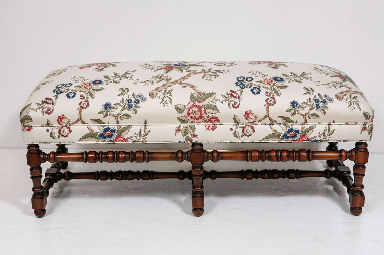 Louis XIII stye upholstered bench with turned walnut or oak legs and stretchers.  Excellent condition with floral fabric.
Previously priced at $1250.00 now reduced to $700.00