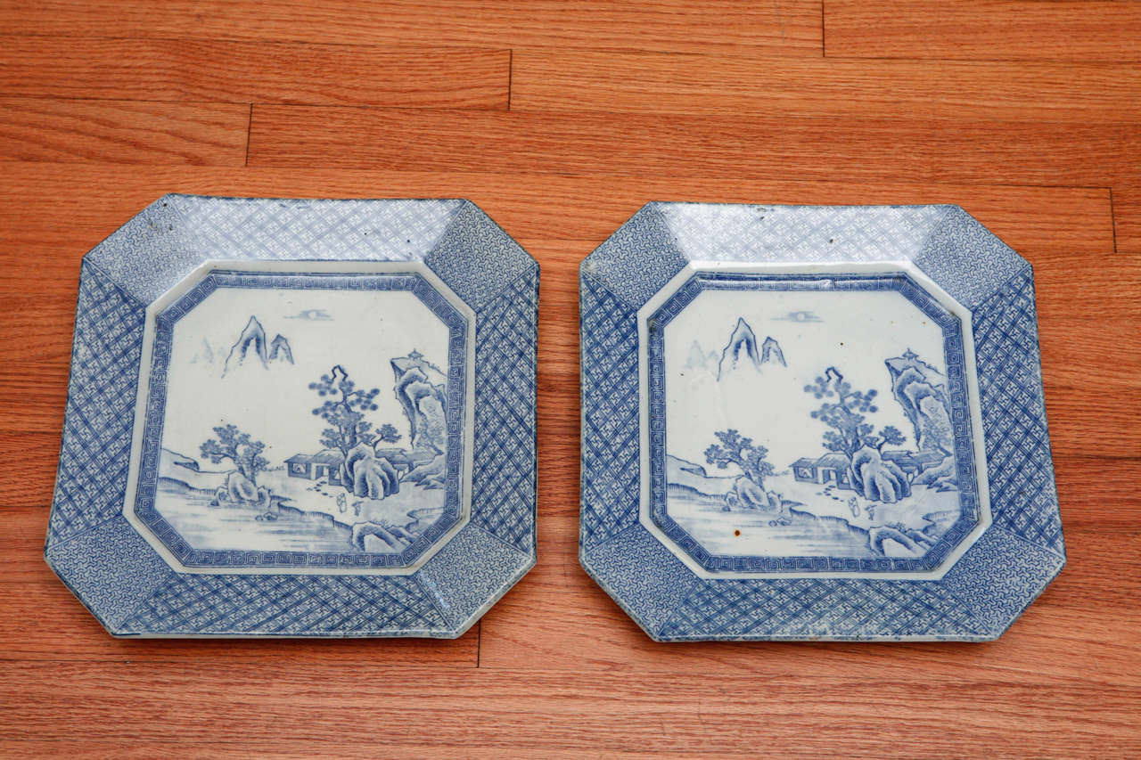 Pair of circa 1920 Japanese blue & white transferware platters.
Mountain and forest scene surrounded by patterned trim on edges.