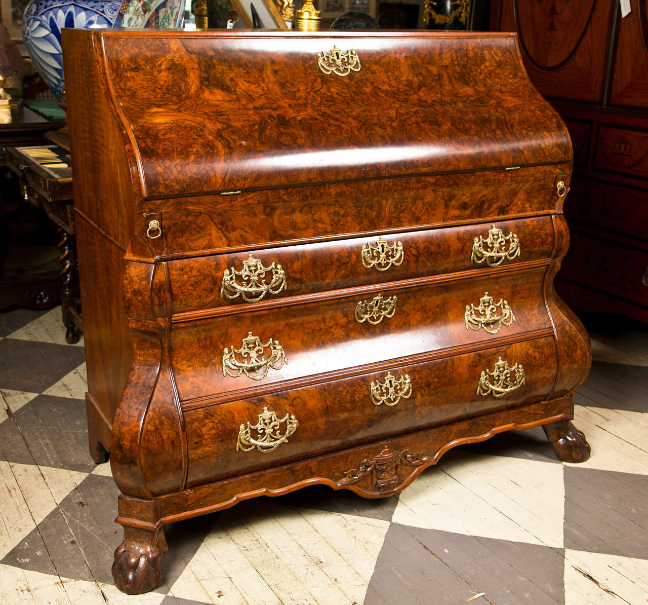 Burr walnut solids and veneers cover the entire secretary. The  S shaped  drop front is very unusual and it rests flat on accommodating pull out sleepers or supports. The interior  with small drawers, 2  pilaster fronted hidden compartments, 