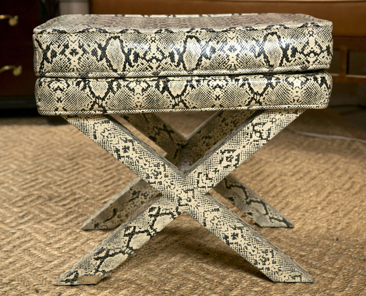 Pair of one-of-a-kind Hollywood Regency style X-base benches, 20th century, upholstered in faux python fabric.