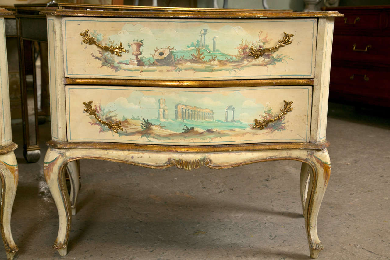 Pair of lovely French Provincial style nightstands, circa 1940s, overall painted and parcel-gilt, the serpentine top over a conforming case fitted with two drawers constructed with oak secondaries, raised on short cabriole legs.