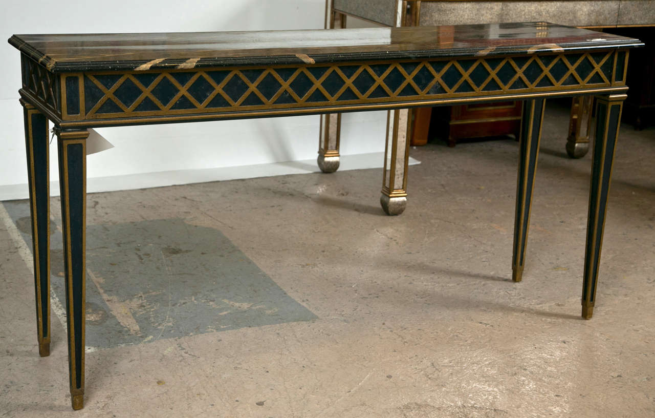 A very charming console table in the Italian Neoclassical style, about 1950s, the painted faux marble top over a narrow frieze decorated with polychromed lattice pattern, raised on four squared tapering legs.