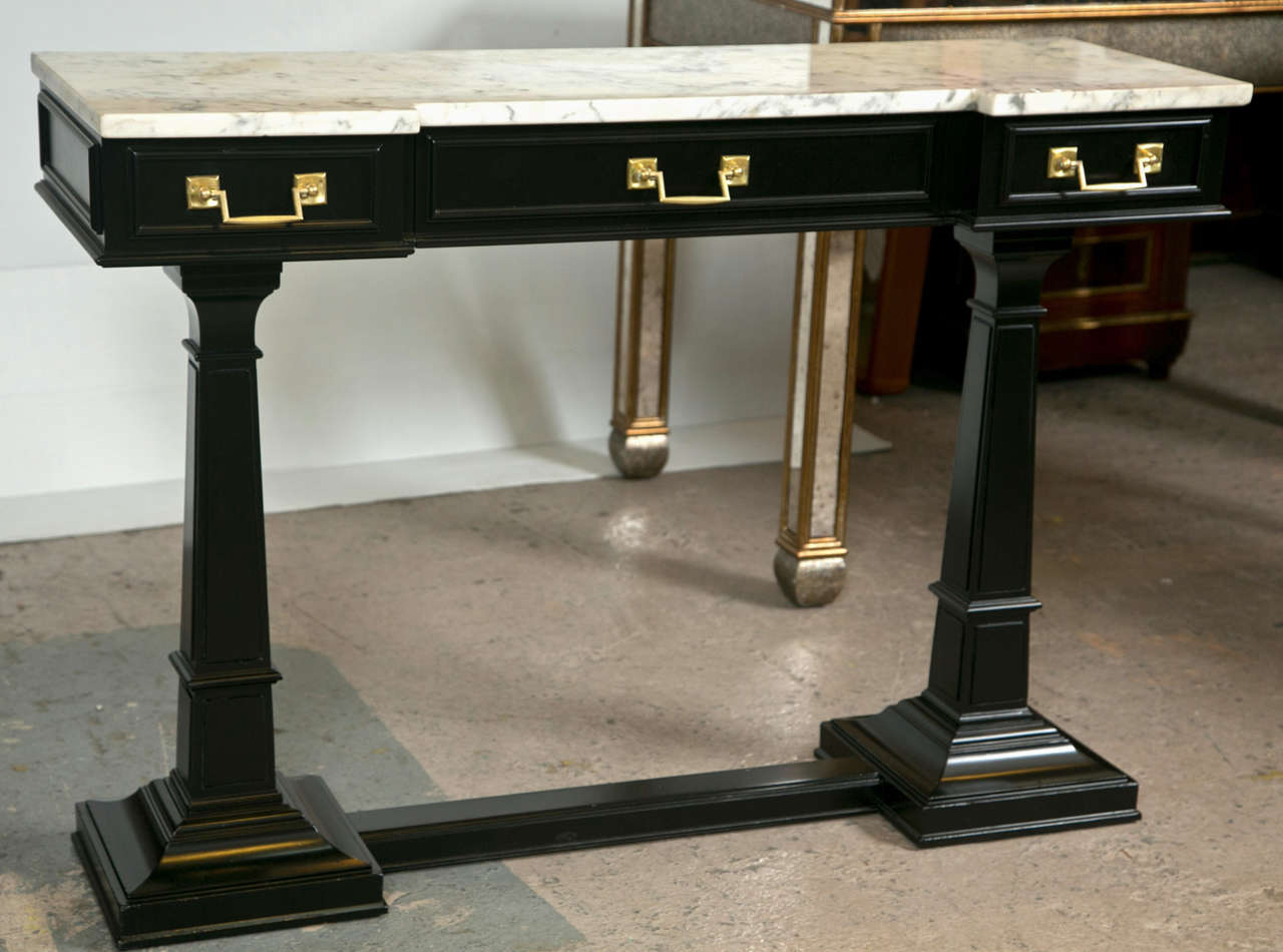 A French Empire style console table, with white shaped marble over a narrow frieze fitted with three small drawers, supported on two squared columnar uprights, joint by a plinth base. Recently refinished.