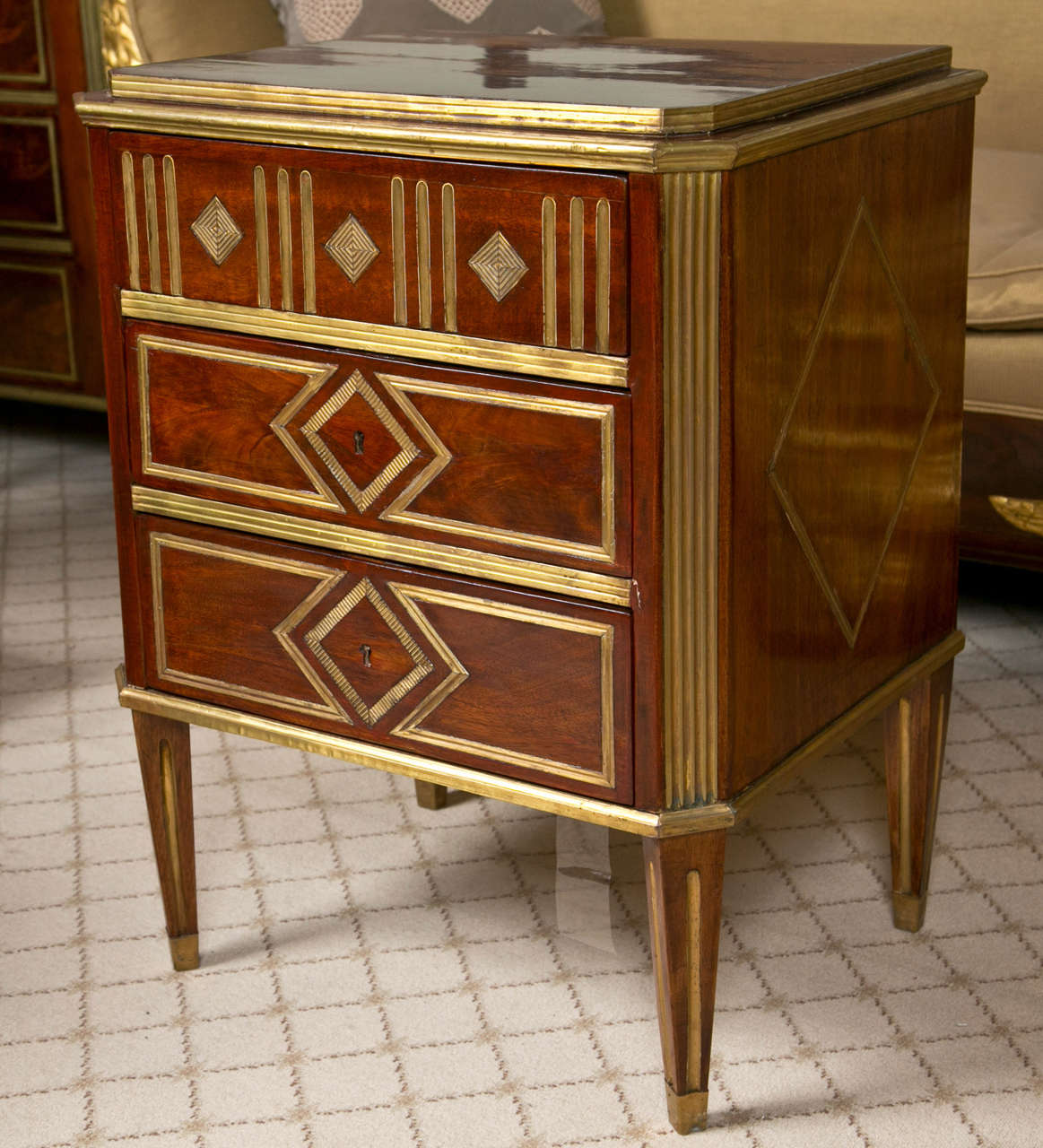 Pair of stunning Russian Neoclassical style nightstands, late 19th century, ormolu banding and mounts throughout the rosewood case, each consists three drawers with oak secondaries all flanked by fluted uprights, raised on tapering legs ending in