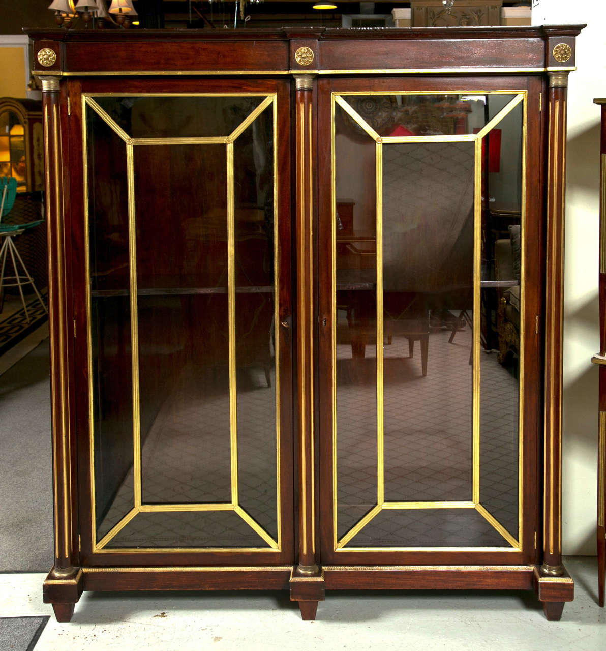 A marvelous early 19th century Russian neoclassical bookcase cabinet. Wonderful gilt metal bronze mounts all over this hand crafted two-door cabinet with a flame mahogany frame. Both doors with decorative framed and boxed bronze mounts flanked by