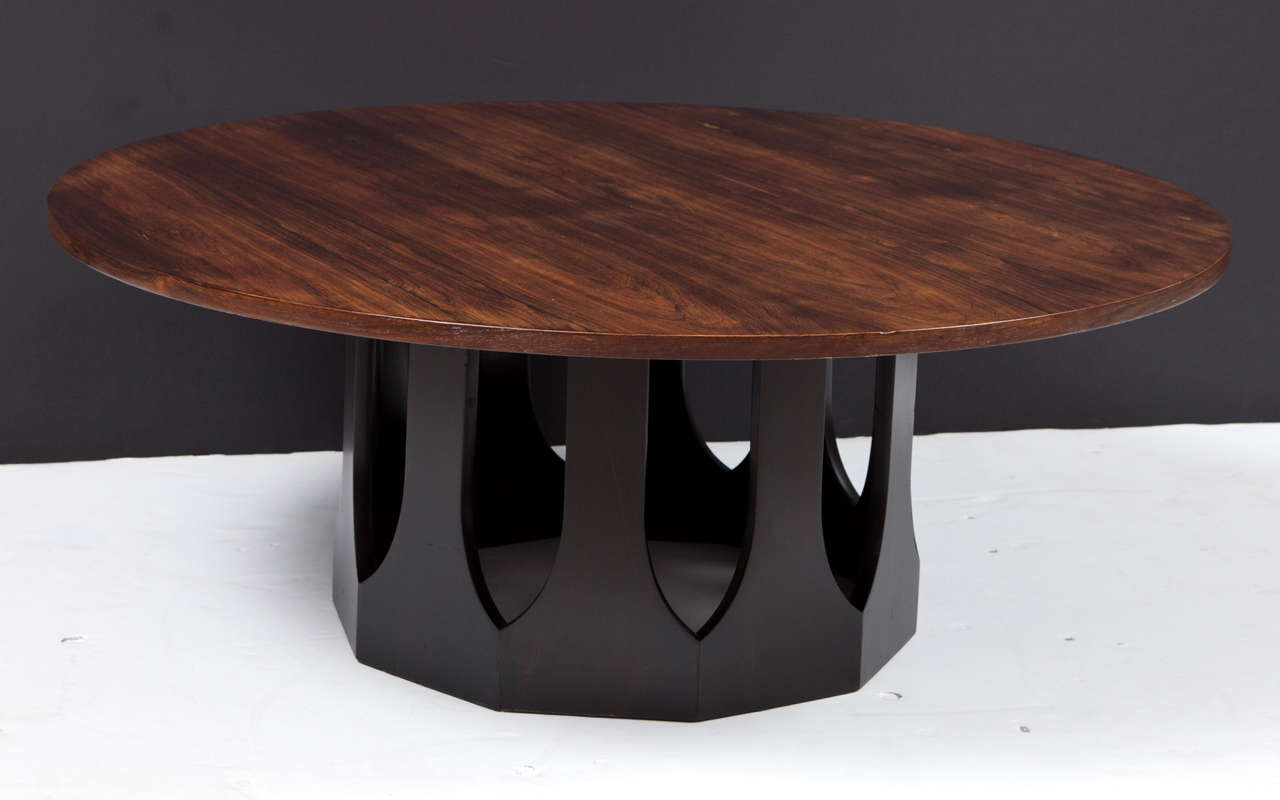 Circular rosewood top supported by a  10-sided ebonized walnut pedestal with spear-shaped cutouts. By Harvey Probber, 1950s.