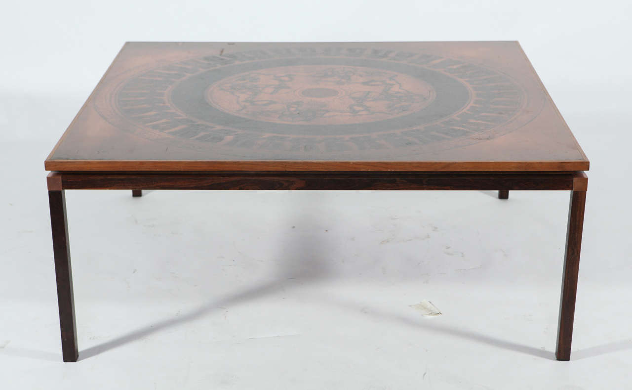 Coffee table with embossed copper plate in the form of world maps. Rosewood frame, naturally patinated. Denmark, c. 1970.